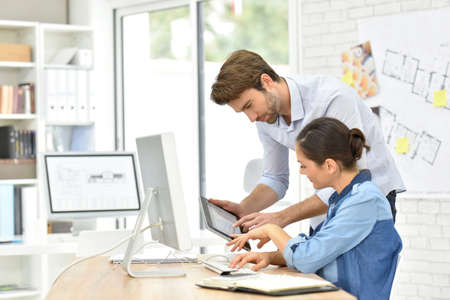 Business people working in office on desktop computer Business people working in office on desktop computer