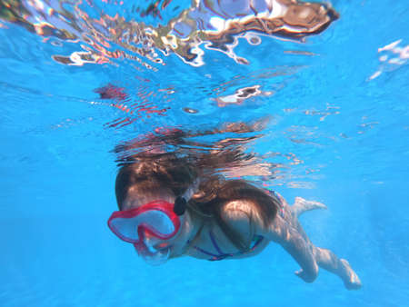 Little girl snorkeling in pool Little girl snorkeling in pool