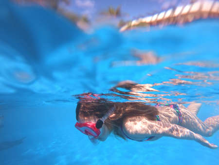 Little girl snorkeling in pool Little girl snorkeling in pool