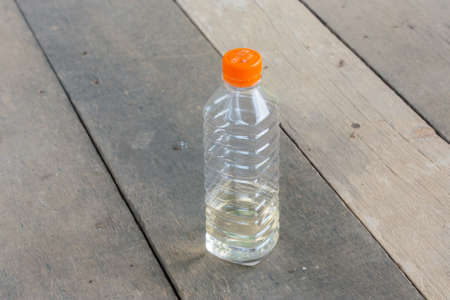 plastic bottle no label on wood plate