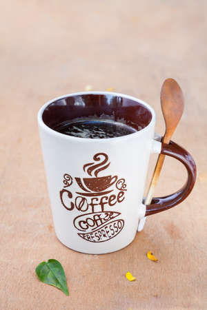 coffee Mug with a spoon and leafの写真素材