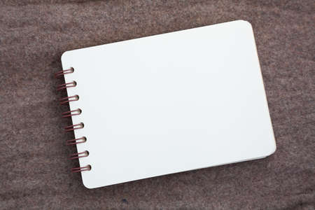 notebook page on brown fabric