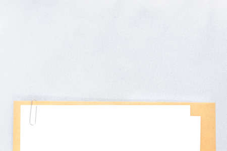 white paper placed on brown paper mouting with clip, leave space for copyの写真素材