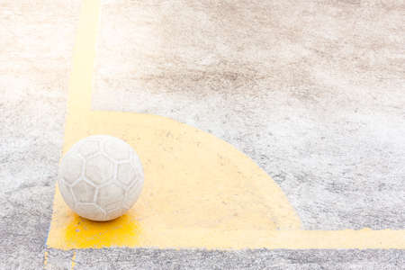 it's a ball of soccer or football place on yellow corner, ground is concreteの写真素材