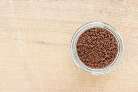 Instant coffee in glass bottles on wood plate background, selective focus, copy spaceの写真素材