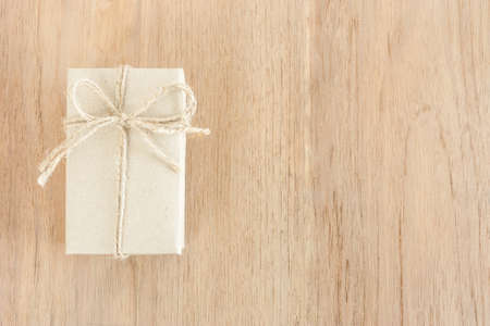 brown handicraft gift box on wood texture with copy space on right sideの写真素材