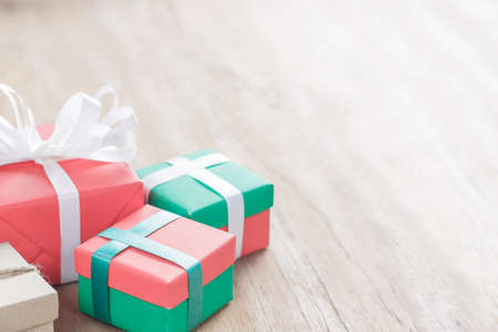 gift box  on left side and copy space on right side of image, selective focus on front green boxの写真素材