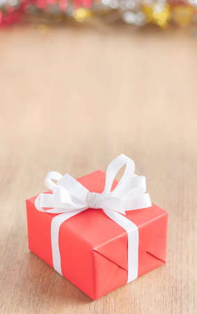 one red gift box on wood table with copy space on top of imageの写真素材