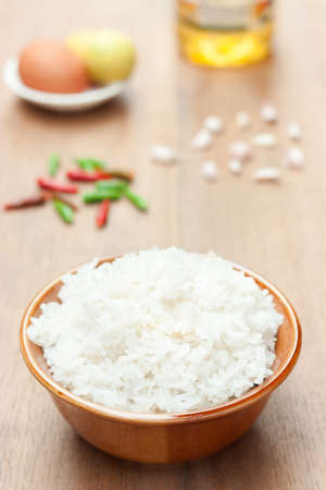 cooked rice with chilli garlic egg and oil on wood table, it's an ingredient for cookingの写真素材