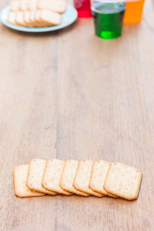 biscuits stacking and copy space , have a sparkling water glass and snack in backgroundの写真素材