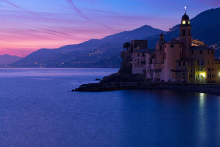 Italy. Camogli town. Mediterranean sea. Views of mountains, sea, beach and town clock. After sunsetの写真素材