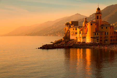 Italy. Camogli town. Mediterranean sea. Views of mountains, sea, beach and town clock. Beautiful colored sunsetの写真素材