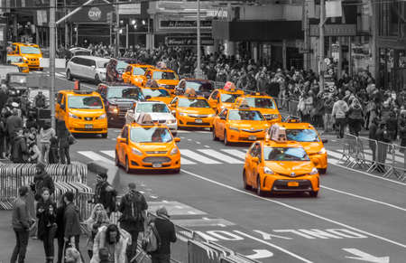 Manhattan. Times square. A lot of yellow cabs surrounded by black-and-white city and crowds....