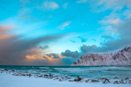 Norway. Lofoten. Winter. Ocean surf between the mountains. Lonely bird over the wavesの写真素材