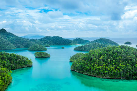 Indonesia. Many small islands, covered with wood and turquoise waterの写真素材