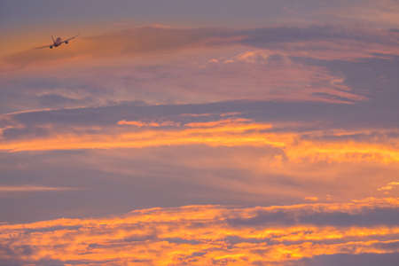 Airplane and boundless beautiful sunset skyの写真素材