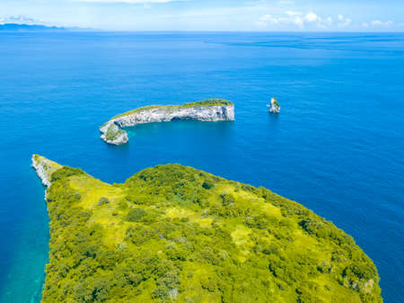 Indonesia. Small rocky tropical islands, overgrown with jungle and azure water of the ocean. Aerial...
