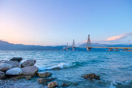 Greek cable-stayed bridge over the Gulf of Corinth. Rion-Antirion. Clear evening sky over the mountain shoreの写真素材