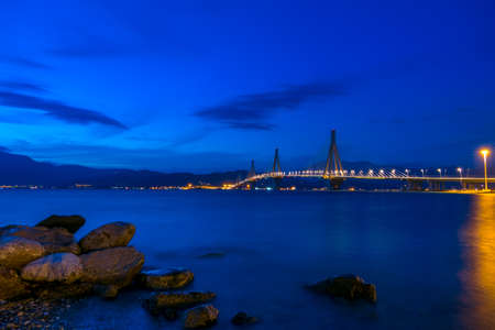 Greek cable-stayed bridge over the Gulf of Corinth. Rion-Antirion. Night sky over the mountain shoreの写真素材