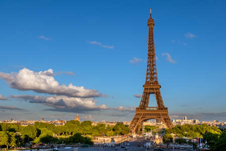 France. Paris. Eiffel Tower in the sunset rays of the sun. Low cloud in the blue skyの写真素材