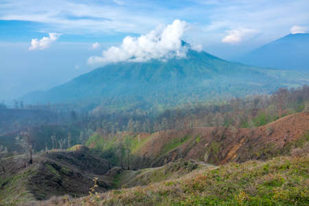 Indonesia. Java island. Morning. Clouds in the blue sky near the crater of the volcano