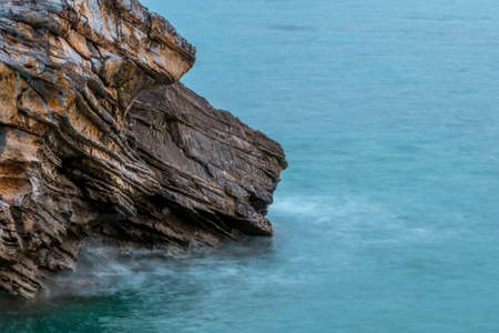 Textured rock by the sea close-up