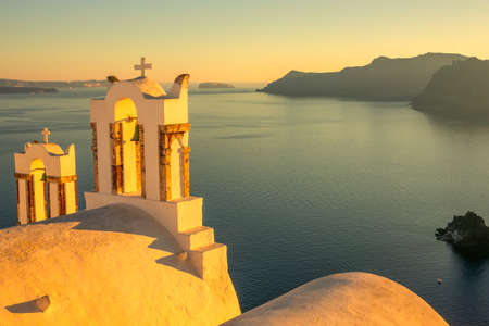 Greece. Santorini. Thira island. Crosses on the greek church in Oia at sunsetの写真素材