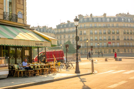 France. Summer sunny morning in Paris. People have breakfast in a street cafÃ©のeditorial素材