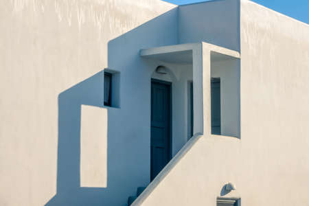 Walls of a white building in sunny weather. Porch with steps at sunsetの写真素材