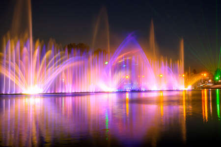 Summer night. Laser show and color fountainの写真素材