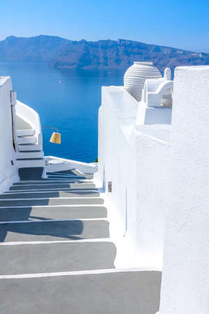 Greece. Sunny summer day on the island of Santorini. Traditional white staircase with gray steps overlooking the seaの写真素材