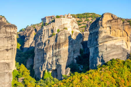 Greece. Clear summer day in Meteora. Several buildings of a rock monastery with red roofs against a cloudless blue skyのeditorial素材
