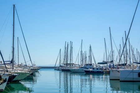 Sunny summer day. Blue sky and lot of sailing yachts in a marinaの写真素材