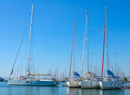 Summer sunny day and blue sky. Large sailing yachts at the pier of the yacht marinaの写真素材