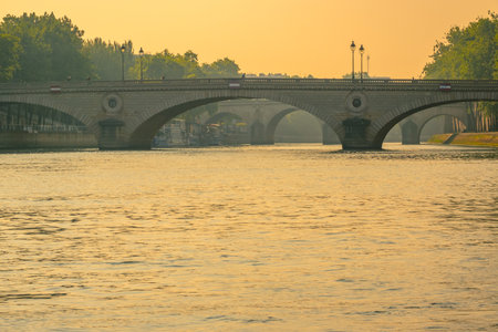 France. Stone bridges over the river Seine in Paris and golden sunsetの写真素材