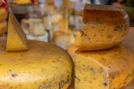 Netherlands. Farmers market in Amsterdam. Many different varieties and large heads of Dutch cheeseの写真素材