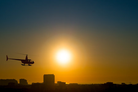 Ukraine. Sunrise in a clear sky over the coastal city of Odessa. Helicopter silhouetteの写真素材