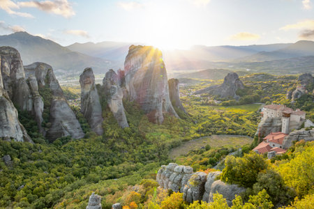 Northern Greece. The small rock monastery of Meteora in the mountains of Thessaly. Summer sunset rays over the green valley off Kalambakaの写真素材