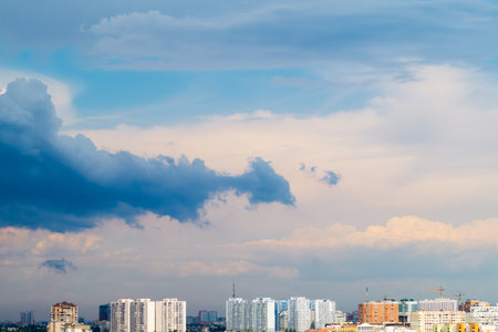Rooftops of the city on a sunny day. Cloudy weather threatens to turn into a stormの写真素材