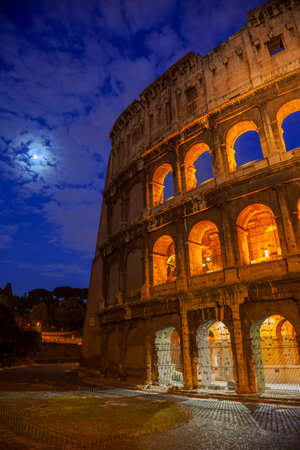 Italy. Moonlit summer night in Rome. The Colosseum illuminated at nightの写真素材