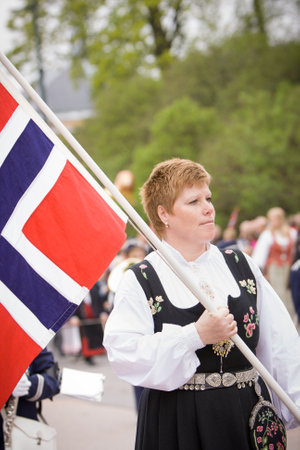 OSLO / NORWAY - May 17, 2010: National day in Norway. Norwegian woman in the national costume at traditional celebration and parade on Karl Johans Gate street.のeditorial素材
