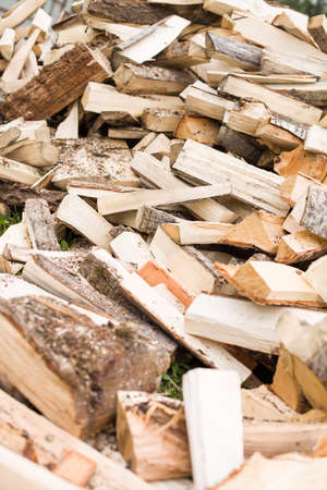 Firewood background - chopped firewood on a stack. Dry chopped firewood logs in a pile. Nature...