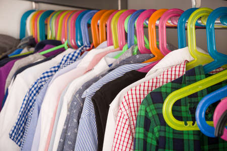 Children clothes on hangers in a room. wardrobe with boy's clothes on hangers. Shopping and...