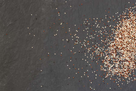 Organic mixed Quinoa on black background. Healthy grains. Mixed red, white and black quinoa.の写真素材