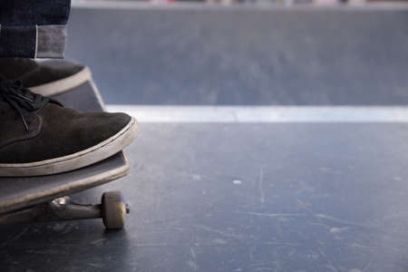Closeup of man's foot on skateboard.  skater riding a skateboard. view of a person riding on his skate.の写真素材