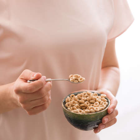 Closeup of woman's hands holding bowl with organic whole wheat cereal. Healthy Breakfast or snack. Healthy food and eating.の写真素材