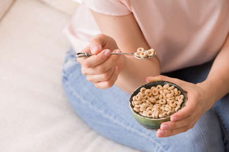Closeup of woman's hands holding bowl with organic whole wheat cereal. Healthy Breakfast or snack. Healthy food and eating.の写真素材