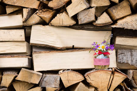 Beautiful summer wild flowers in a nice glass jar on a wooden background. Summer bouquet. Bunch of flowers. Summer time. Present.の写真素材