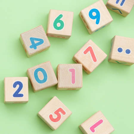Wooden cubes with numbers on light green backgroundの写真素材