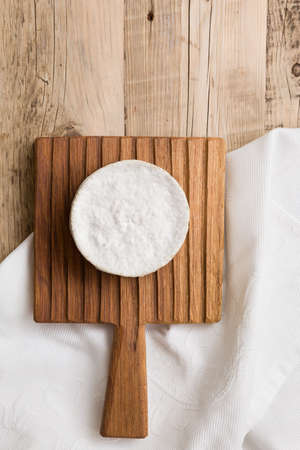 Top view on Camembert cheese on wooden board. Serving French homemade soft cheese. Food conceptの写真素材
